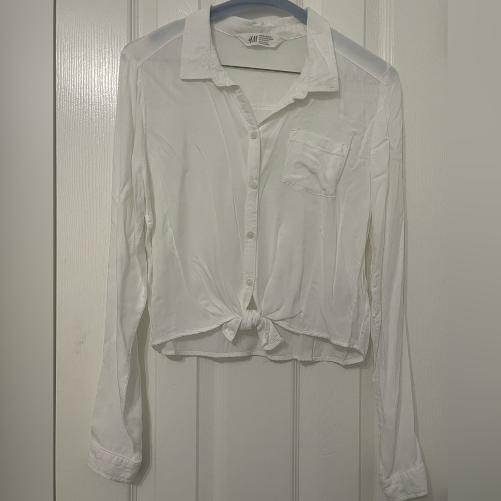 White blouse with front button closure and bow appliqué